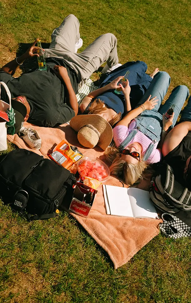 friends laying on a blanket outside