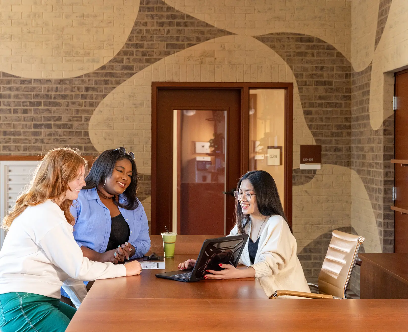 a woman helping residents at the leasing office