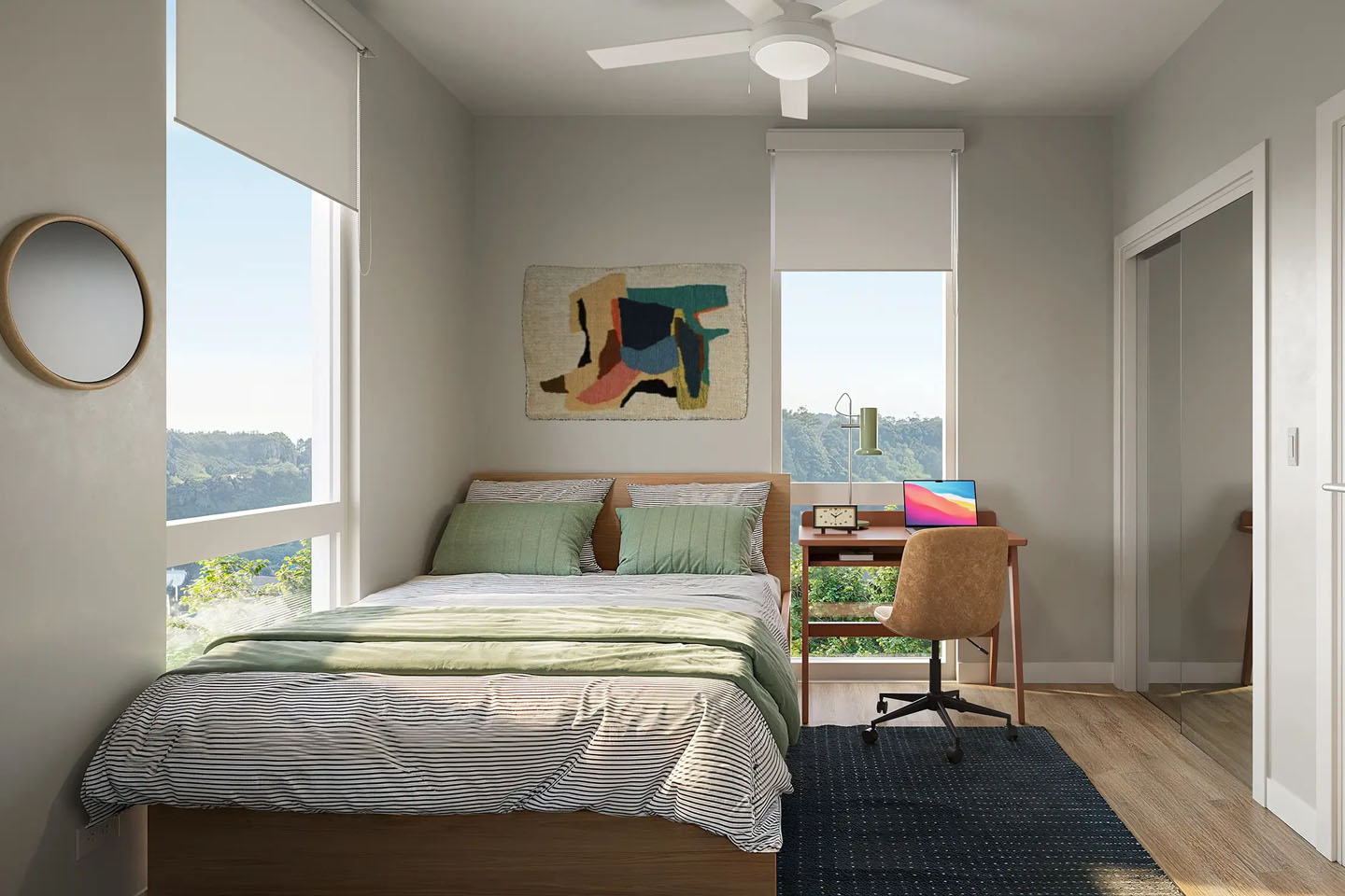 Cozy furnished bedroom with bed, desk table with chair, and large open windows.